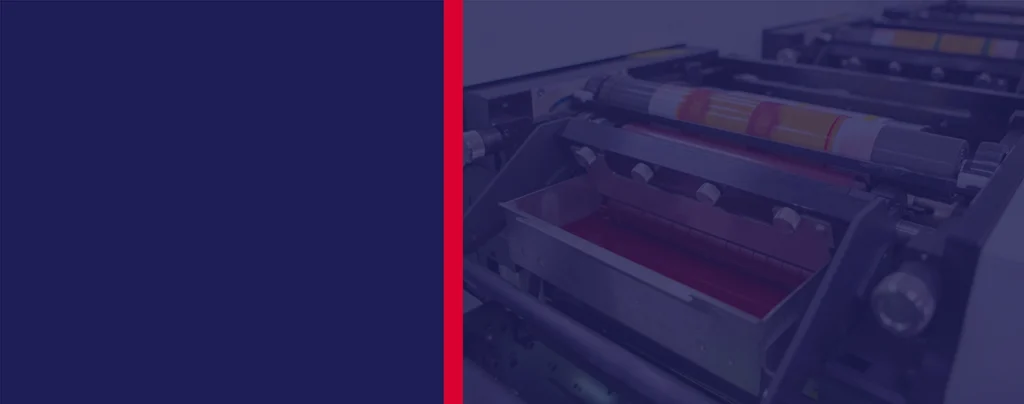 Close-up view of an industrial printing press with rollers and ink trays, partially obscured by a blue overlay and a vertical red line on the left side.
