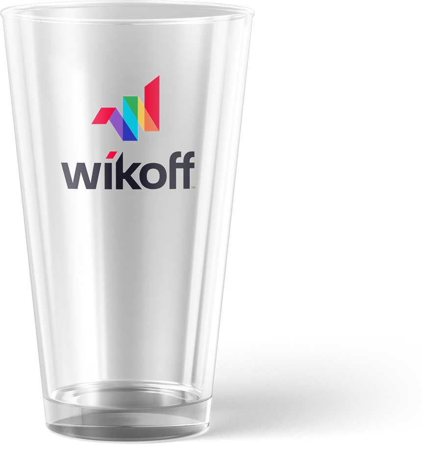 A clear glass with the "wikoff" logo and a colorful geometric design printed on the side.
