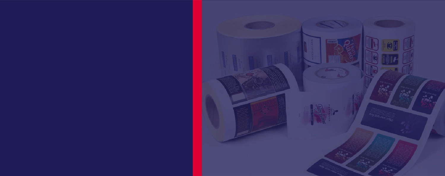 Several rolls of printed labels with various designs are displayed on a surface, with a plain dark blue and red background to the left.